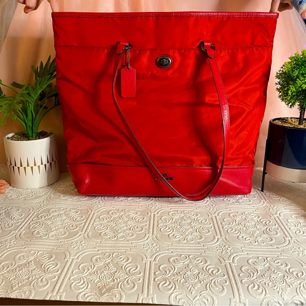 Red Coach tote bag with leather bottom and straps about 14” long